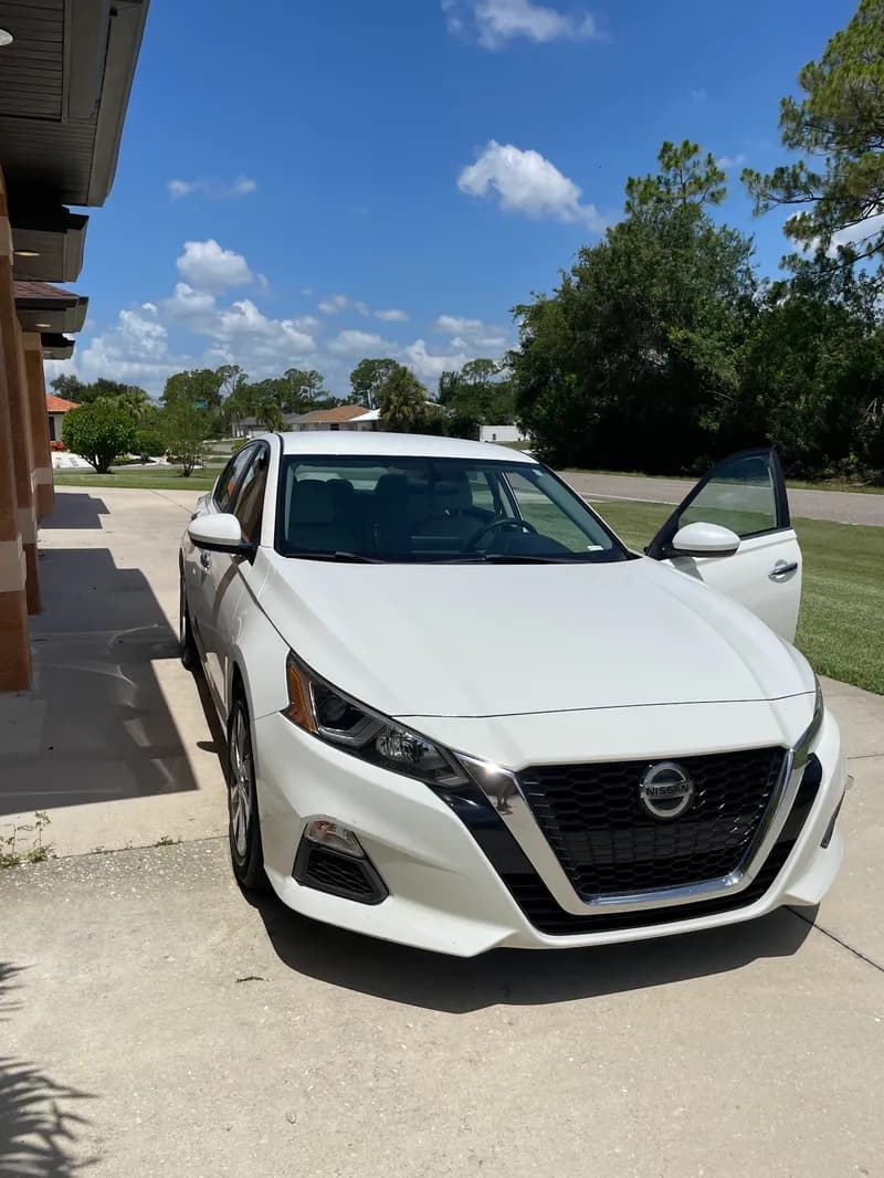 White Nissan Altima sedan freshly exterior detailed in North Port, FL