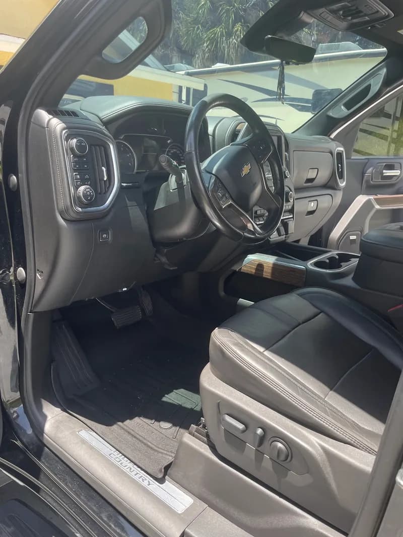 Clean Chevrolet Silverado black leather truck interior after detailing in North Port, FL