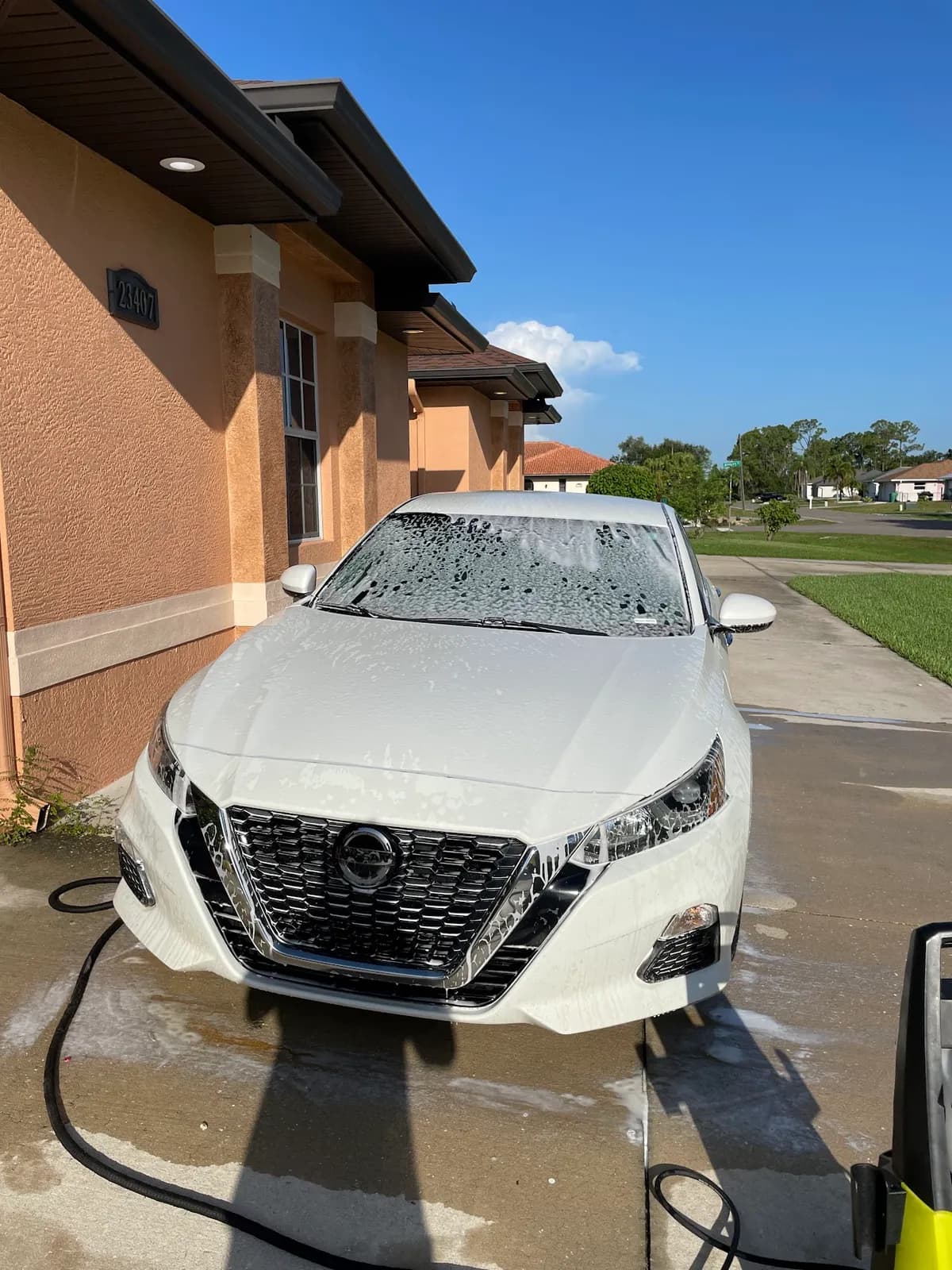 Sansanich Car Detailing mobile service in action — foam hand wash at a customer home in North Port, FL