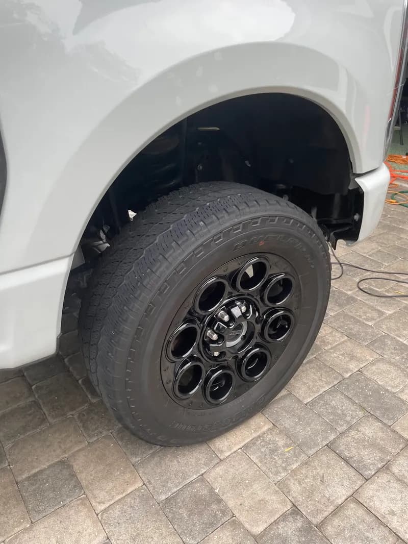 Clean black off-road truck wheel and tire after detail in North Port, FL